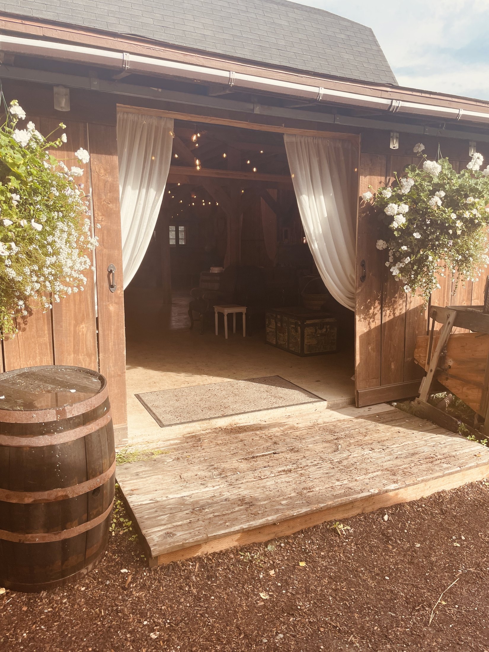 Flower-lined entrance to a rustic wedding barn